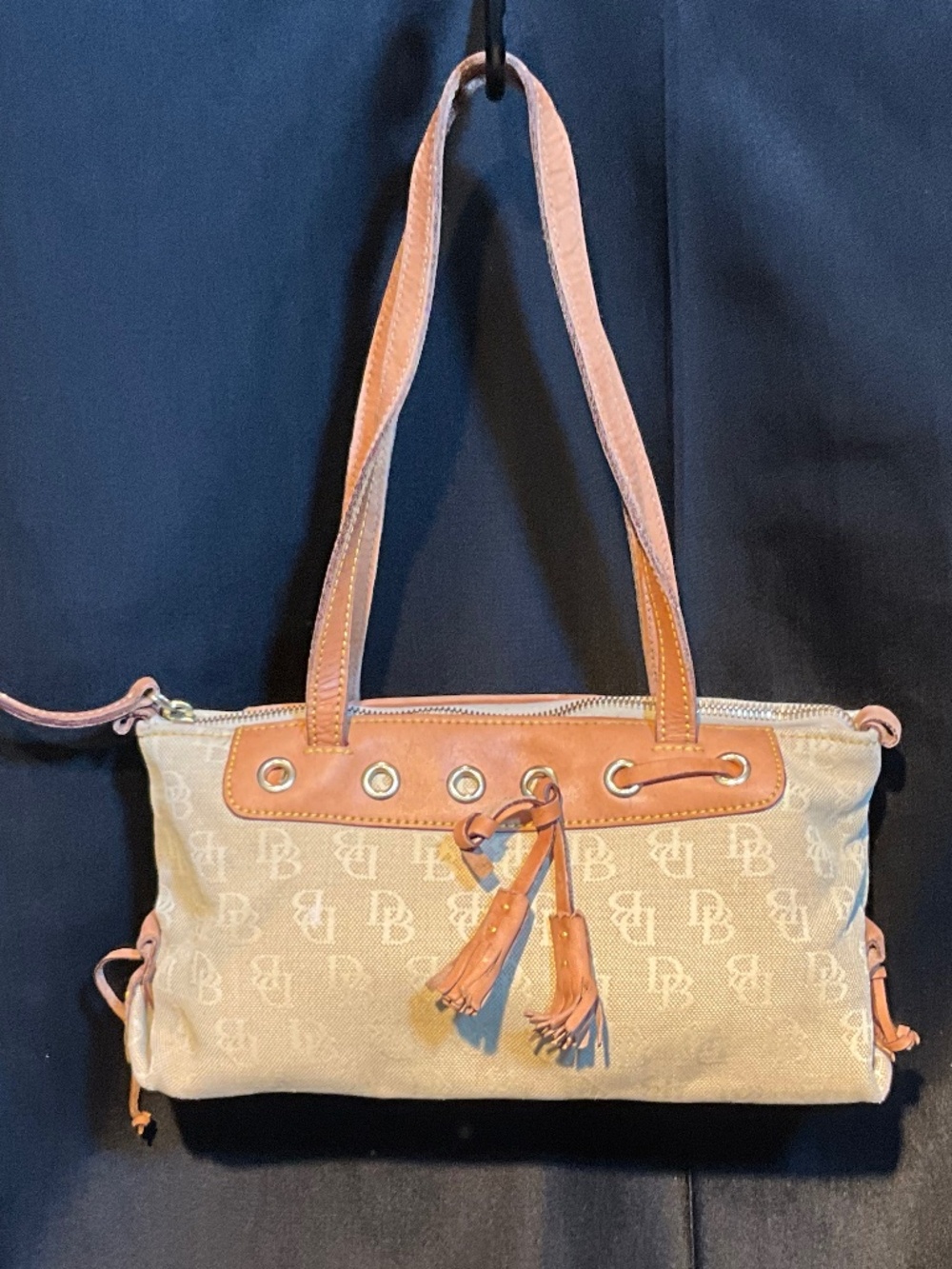 Dooney & Bourke cream on beige signature print hand bad.   H10B